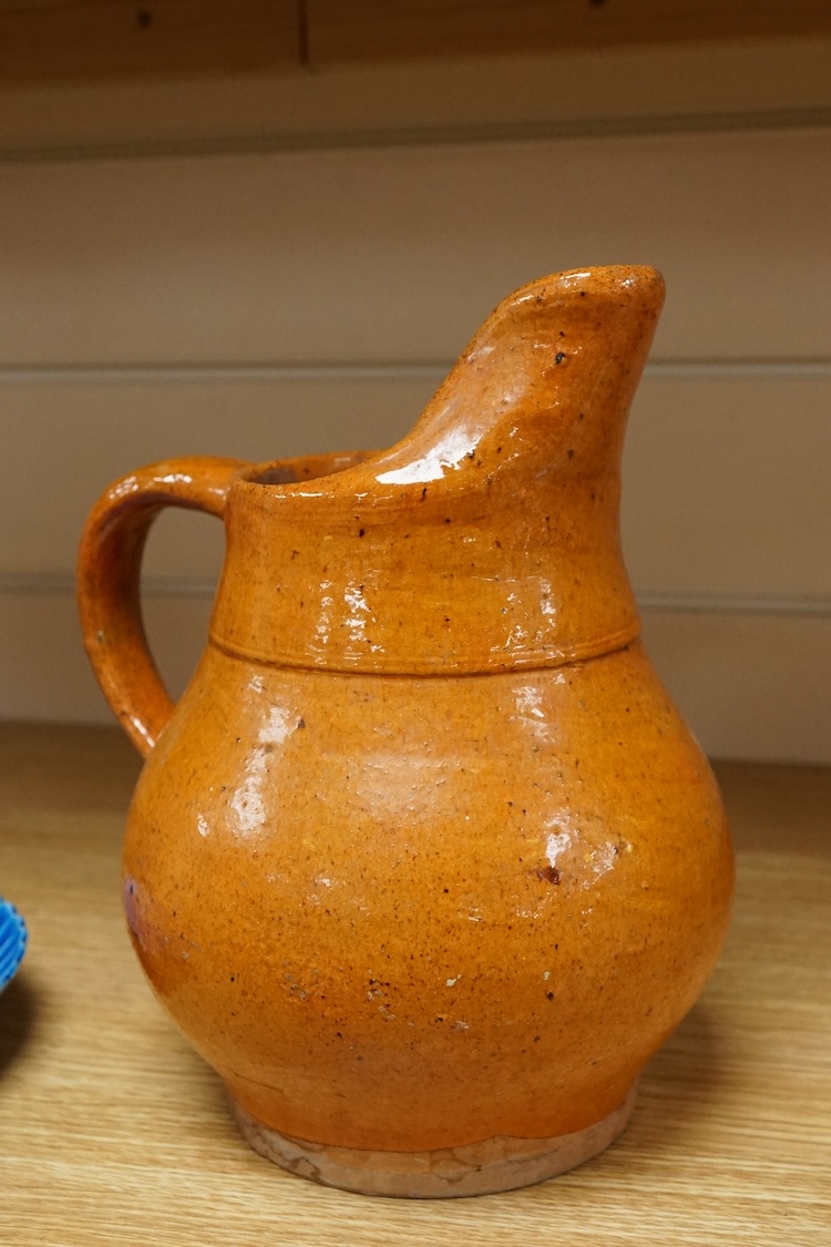 A Chinese blue glazed cylindrical brush pot, Kangxi mark but later, a similar saucer, Qianlong mark but later and a terracotta jug, 21cm